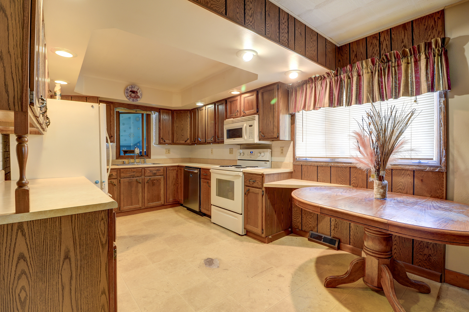 24839 Indian Ridge Road Sterling, IL 61081 - Photo 11 of 33 a kitchen with stainless steel appliances granite countertop a sink a stove and a refrigerator
