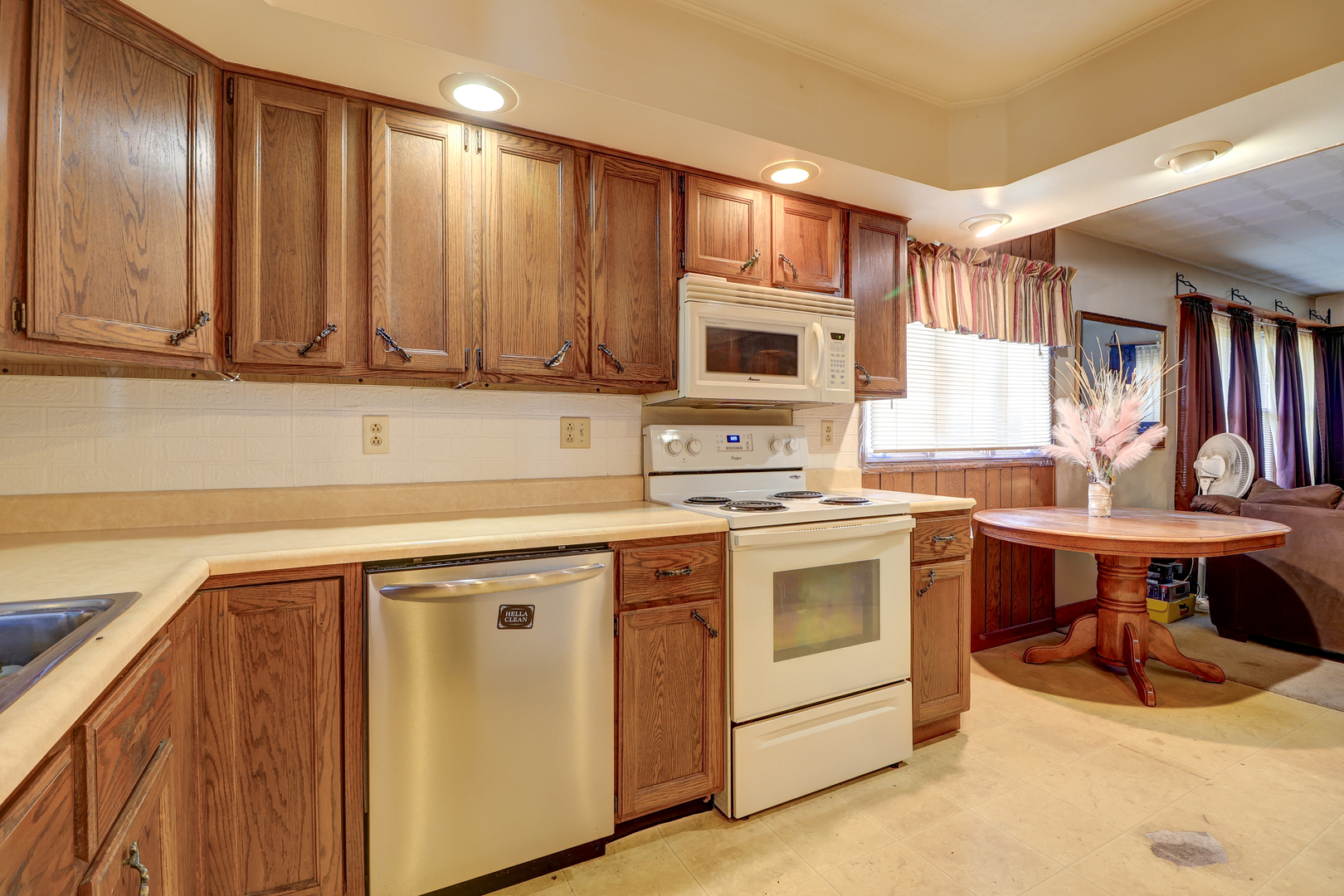 24839 Indian Ridge Road Sterling, IL 61081 - Photo 13 of 33 a kitchen with stainless steel appliances granite countertop a stove a sink and a microwave