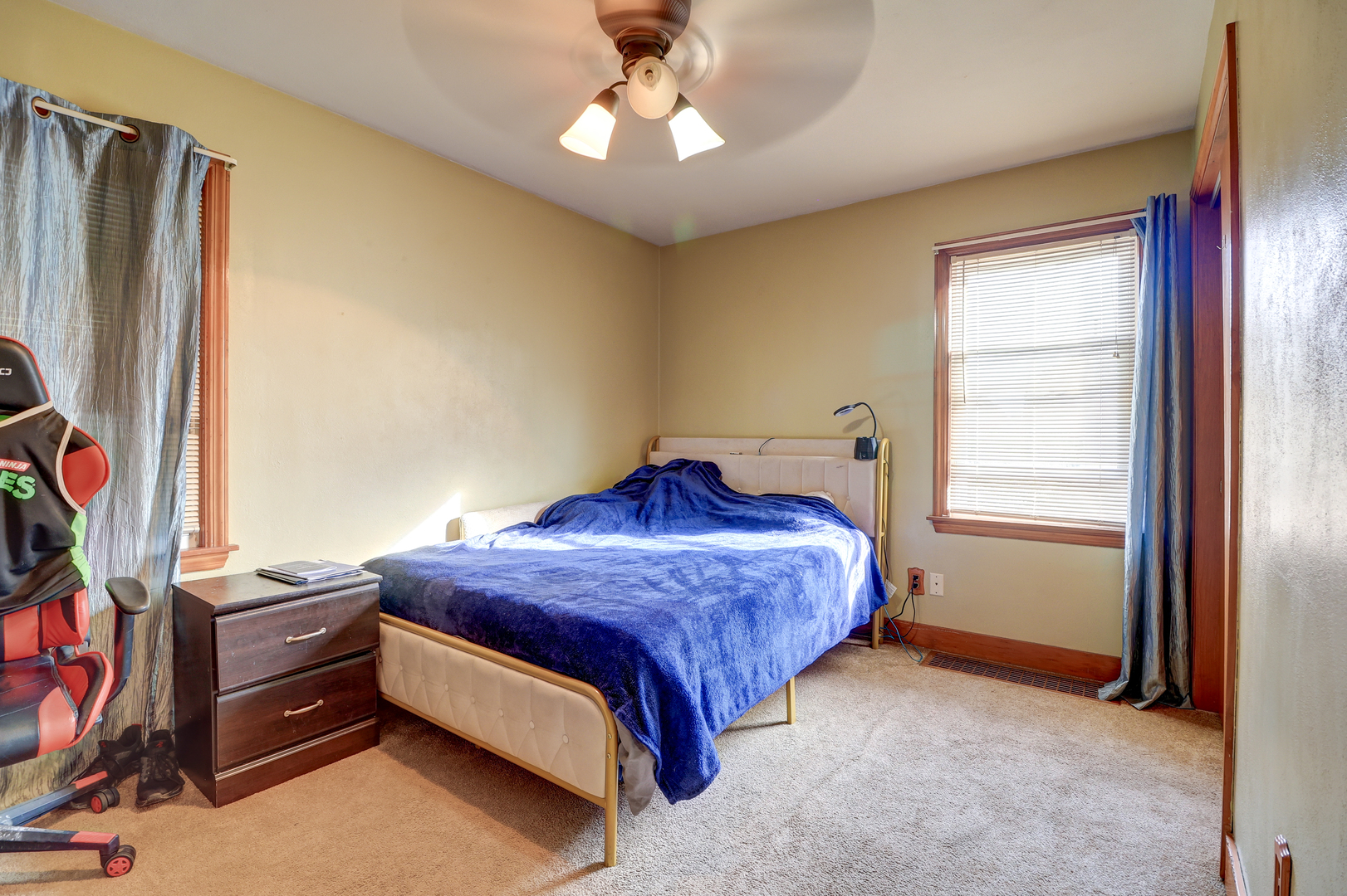 24839 Indian Ridge Road Sterling, IL 61081 - Photo 16 of 33 a spacious bedroom with a bed and a chandelier