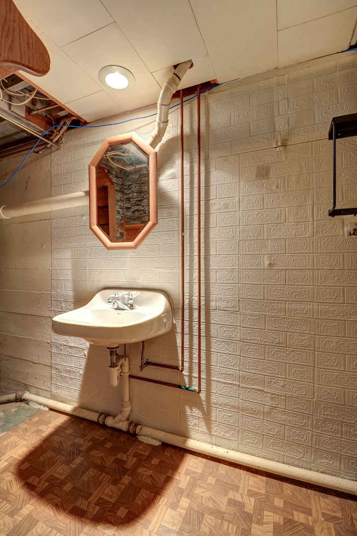 24839 Indian Ridge Road Sterling, IL 61081 - Photo 23 of 33 a bathroom with a sink mirror and shower