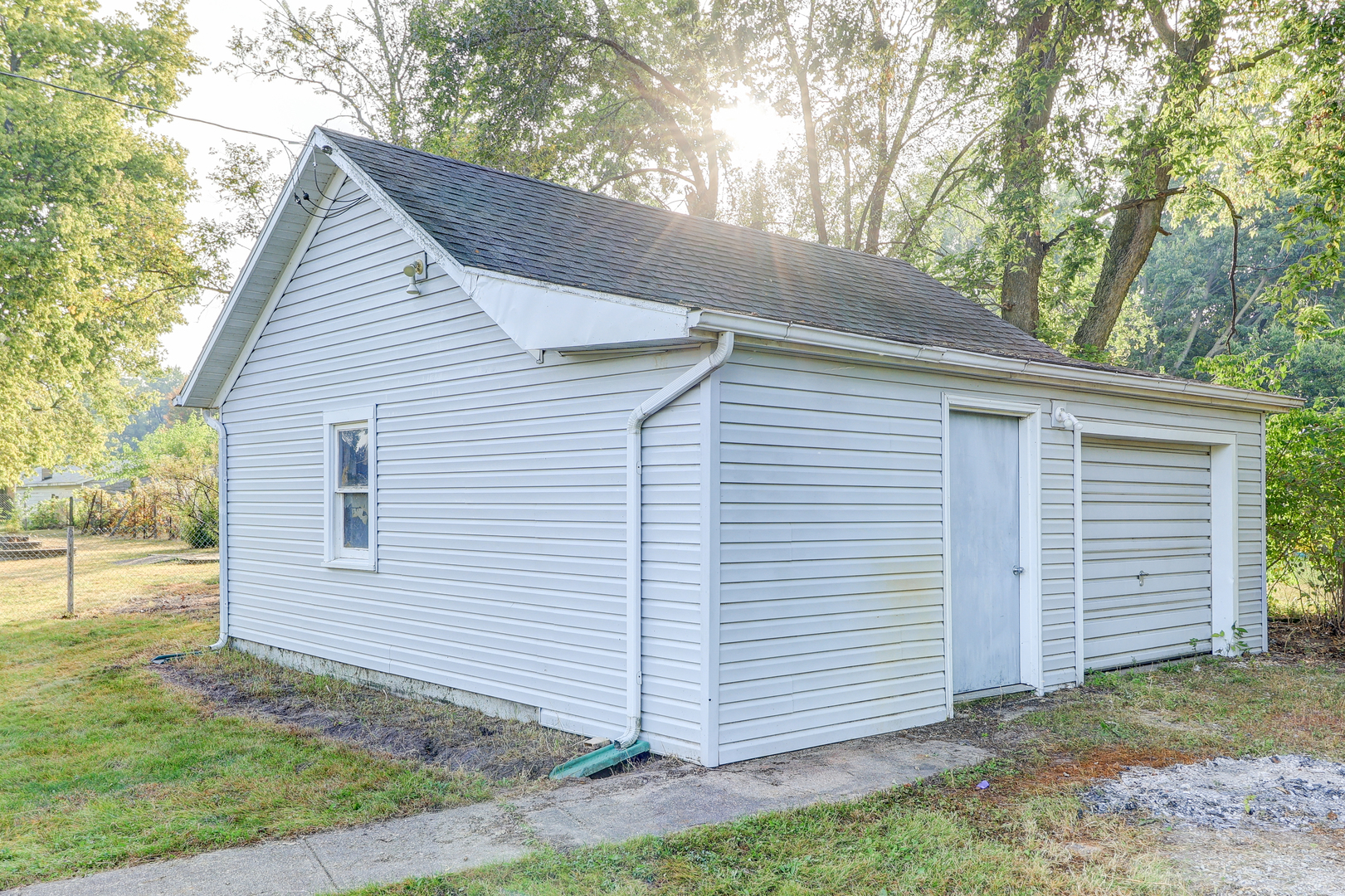 24839 Indian Ridge Road Sterling, IL 61081 - Photo 6 of 33 a view of small white building with large trees and a barn