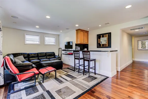 a living room with furniture and wooden floor