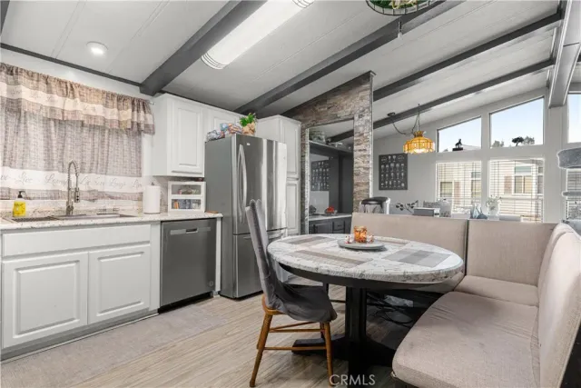 a kitchen with granite countertop a sink stainless steel appliances and cabinets