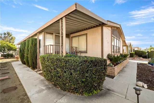 a view of a house with backyard and sitting area
