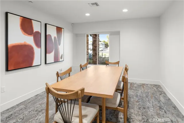 a backyard of a house with table and chairs