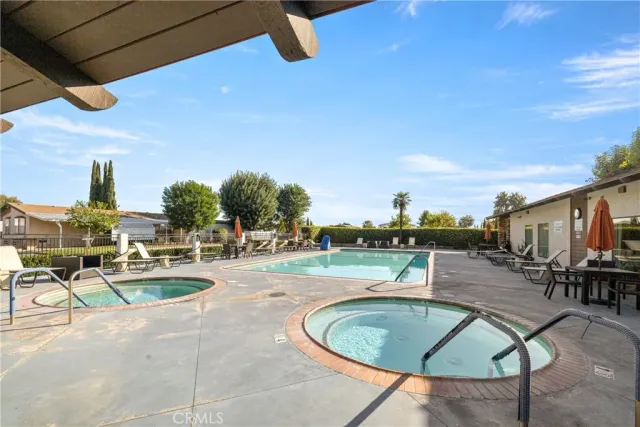 a living room with furniture a ceiling fan and a window