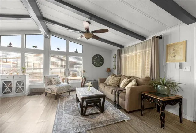 a view of a dining room with furniture a chandelier and wooden floor