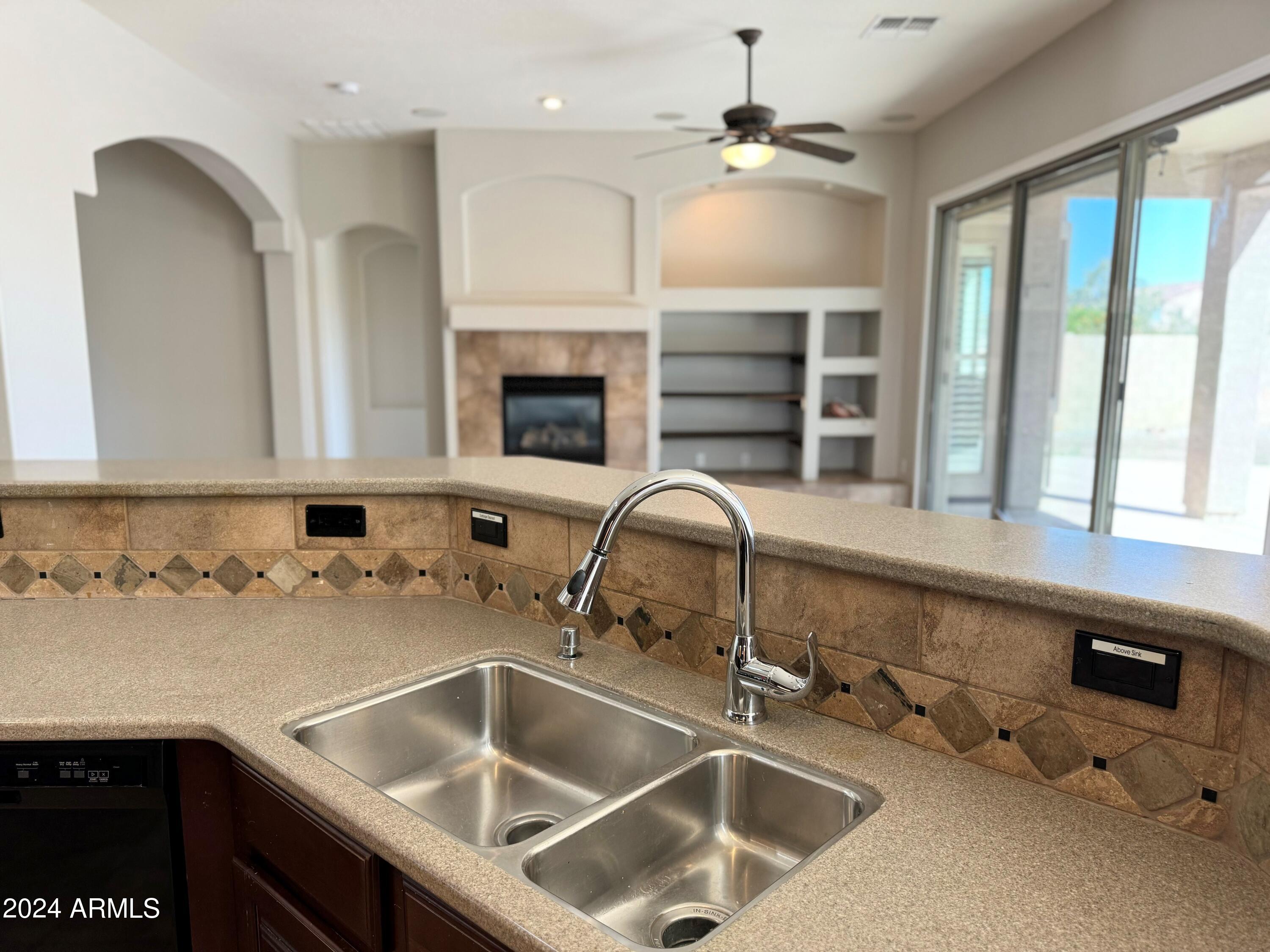 18426 West Piedmont Road Goodyear, AZ 85338 - Photo 8 of 25 a kitchen with a sink cabinets and window