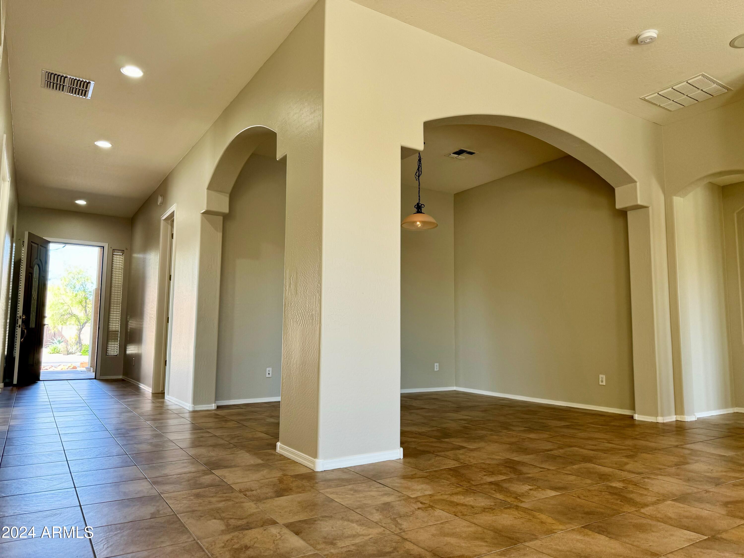 18426 West Piedmont Road Goodyear, AZ 85338 - Photo 10 of 25 a view of a hallway with wooden floor and a bathroom