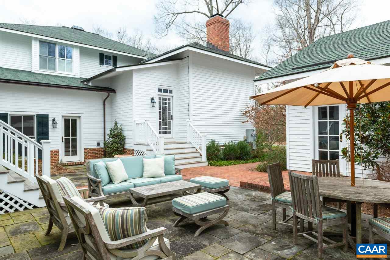 2340 Homestead Farm Road Free Union, VA 22940 - Photo 43 of 47 a view of a patio with couches table and chairs under an umbrella