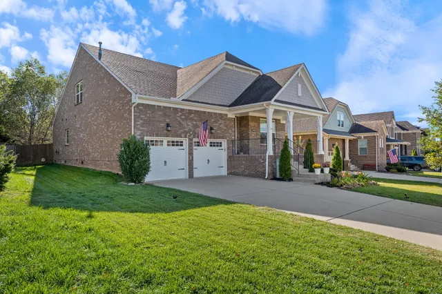 a front view of a house with a yard and garage
