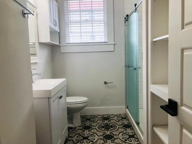 a bathroom with a toilet and a shower