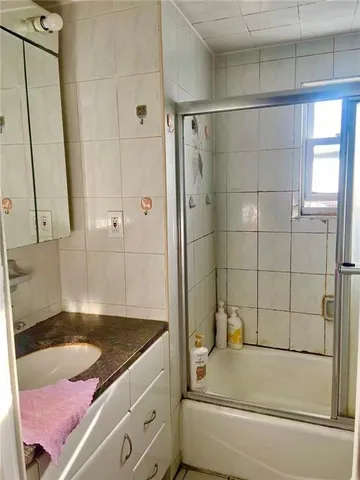 a bathroom with a granite countertop bathtub sink vanity and mirror