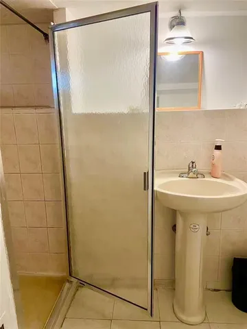 a bathroom with a sink and shower