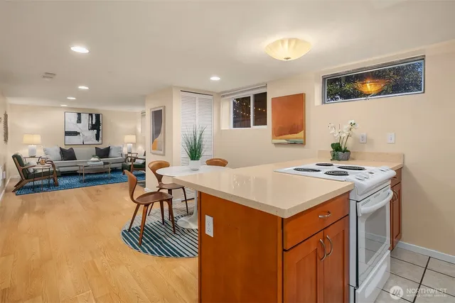 a kitchen with a table chairs stove and cabinets
