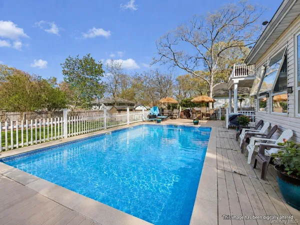 a view of a swimming pool with outdoor seating