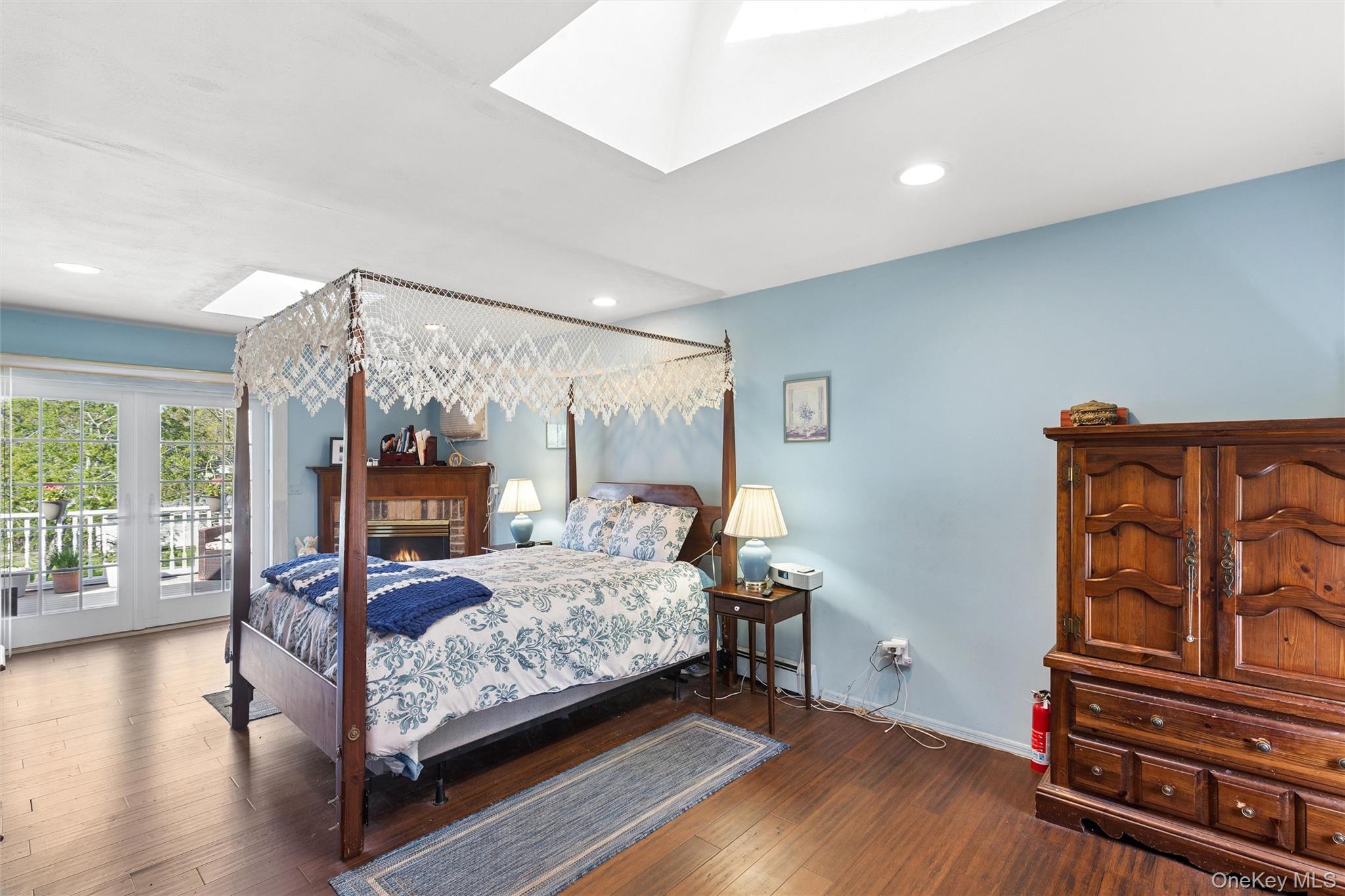 5045 Main Bayview Road Southold, NY 11971 - Photo 11 of 30 a bedroom with a bed wooden floor and window