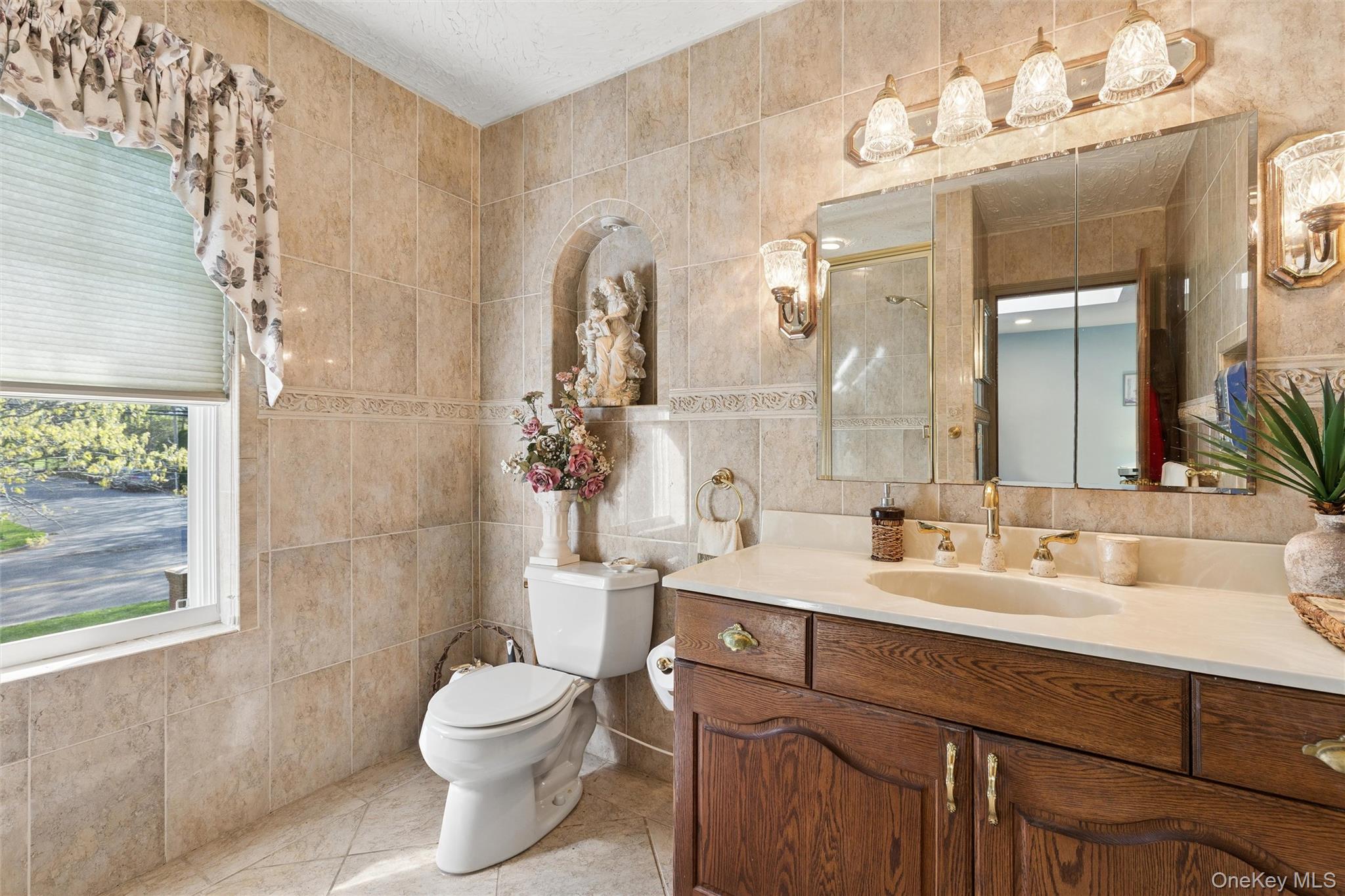 5045 Main Bayview Road Southold, NY 11971 - Photo 12 of 30 a bathroom with a sink a toilet and a mirror