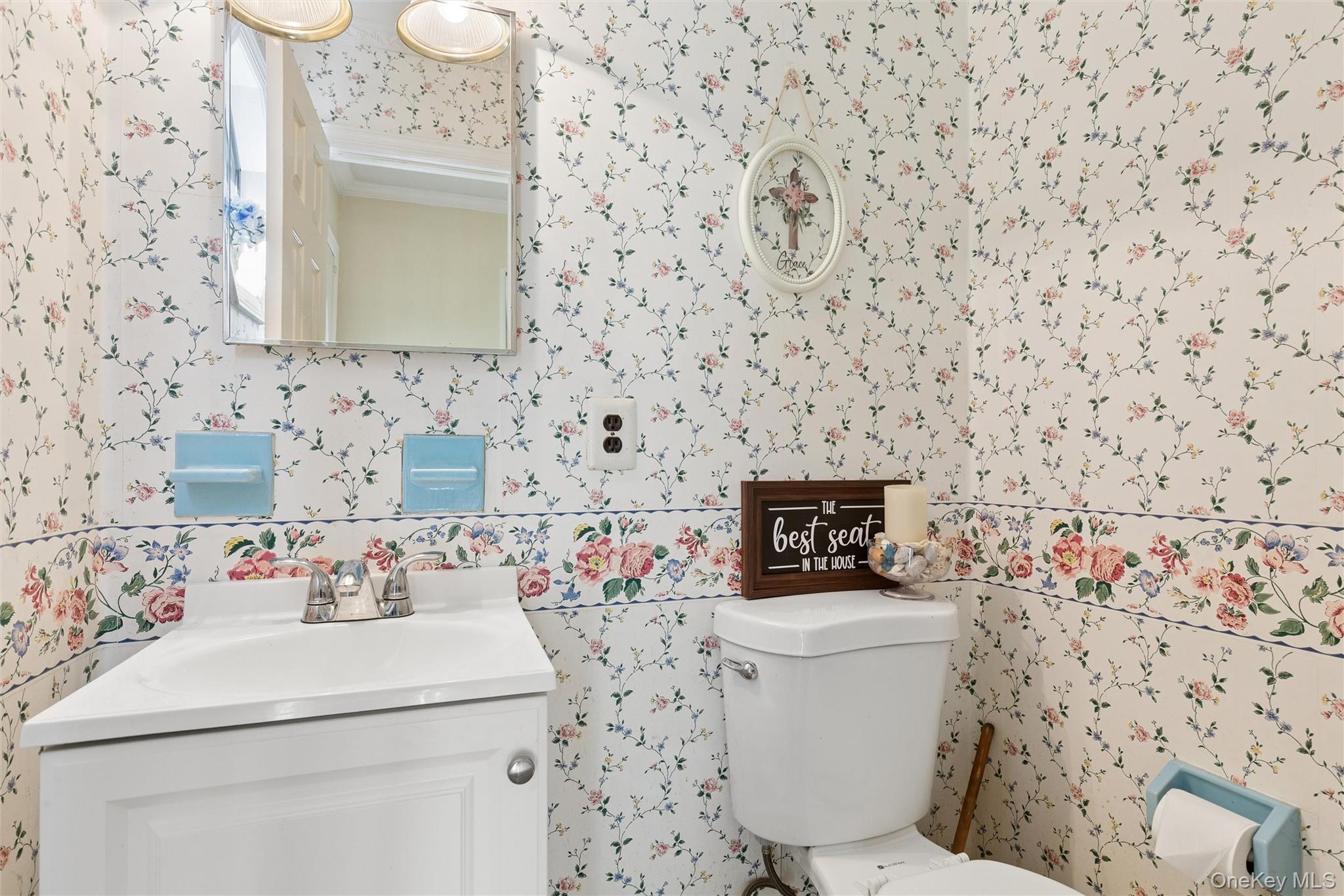 5045 Main Bayview Road Southold, NY 11971 - Photo 17 of 30 a bathroom with a toilet sink and mirror