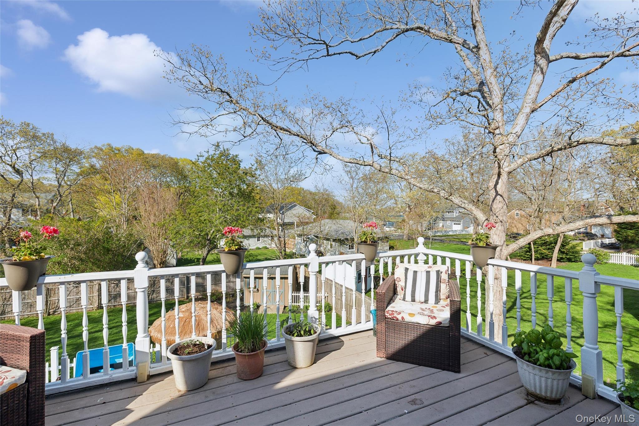 5045 Main Bayview Road Southold, NY 11971 - Photo 18 of 30 a view of a deck with two chair and wooden floor