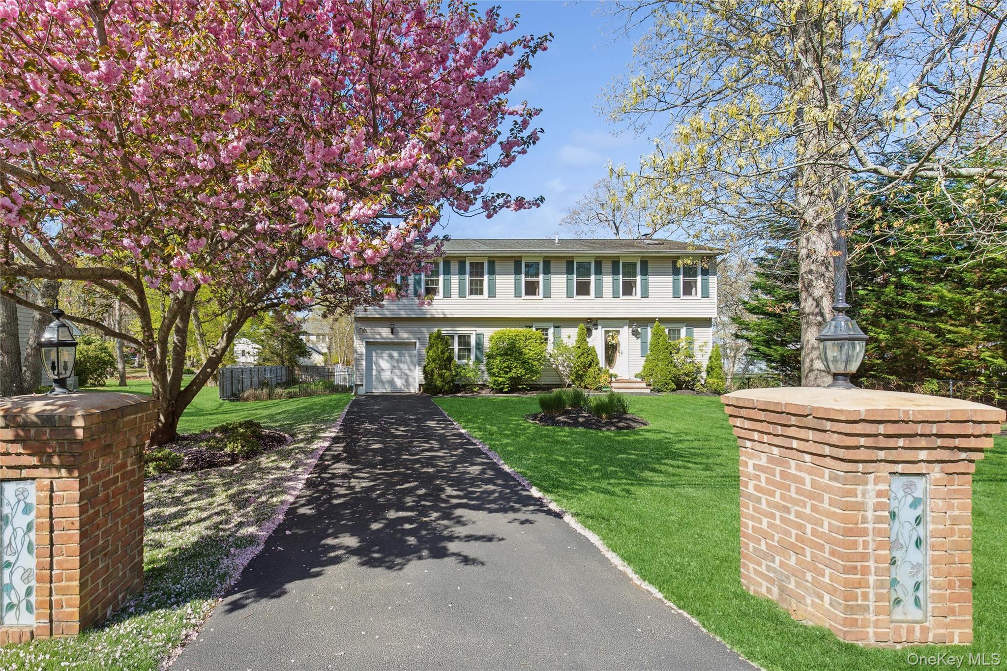 5045 Main Bayview Road Southold, NY 11971 - Photo 2 of 30 a front view of a house with a garden