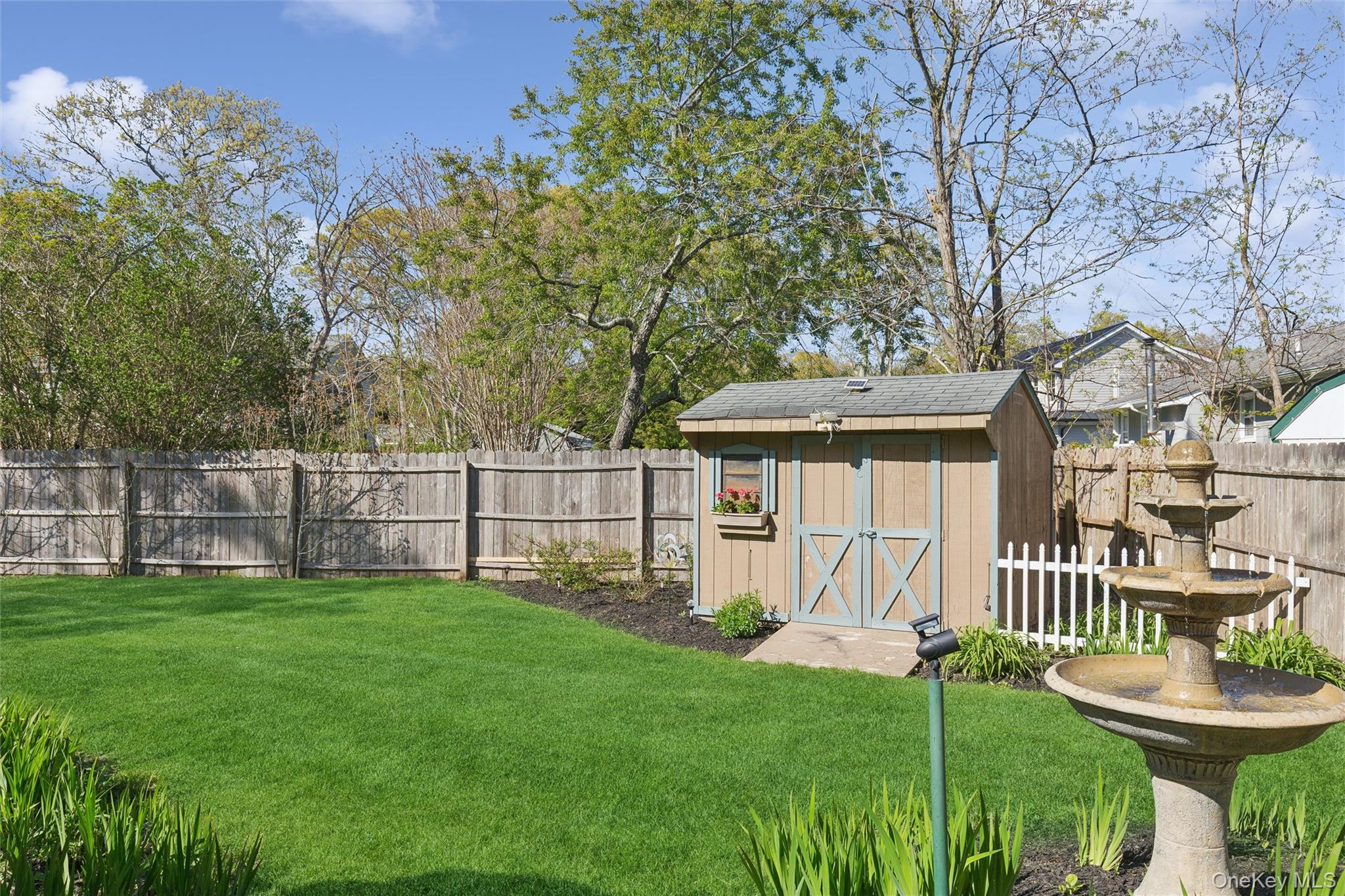 5045 Main Bayview Road Southold, NY 11971 - Photo 22 of 30 a view of a house with a yard and sitting area