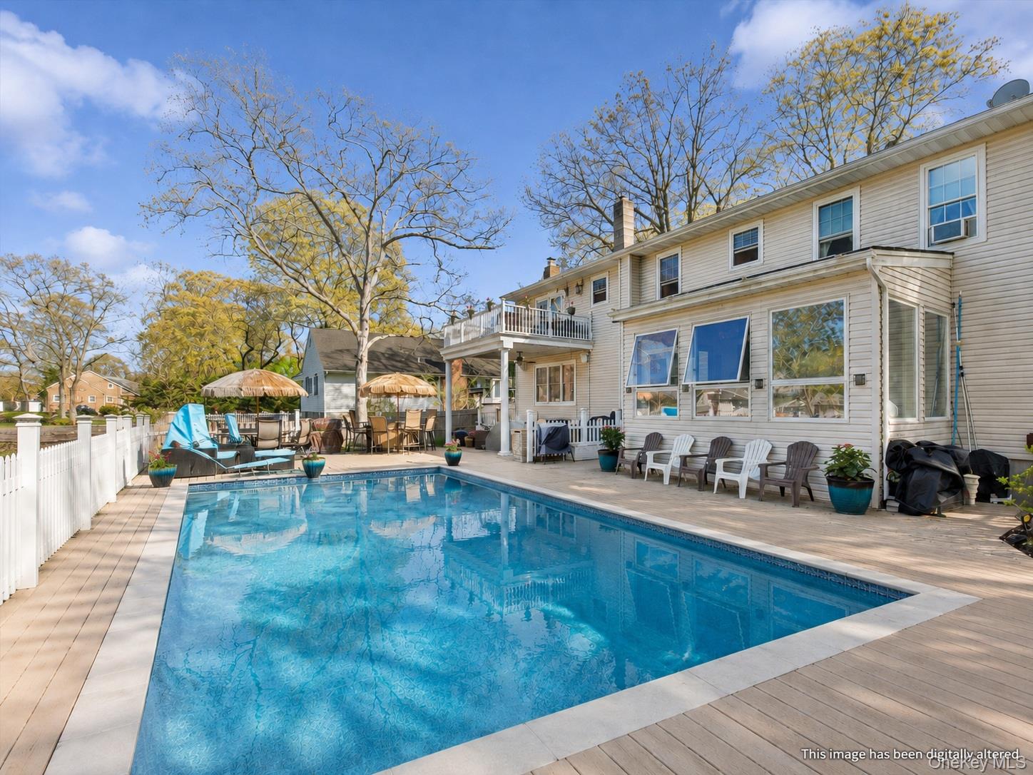 5045 Main Bayview Road Southold, NY 11971 - Photo 25 of 30 a view of a house with swimming pool and sitting area