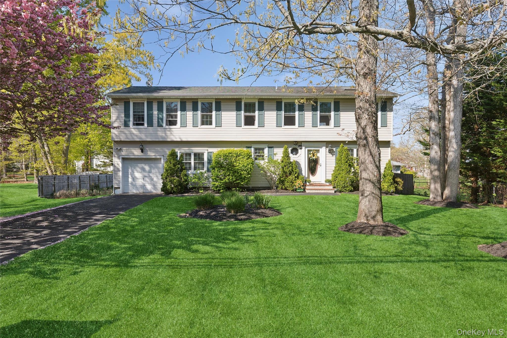 5045 Main Bayview Road Southold, NY 11971 - Photo 3 of 30 a front view of a house with a yard