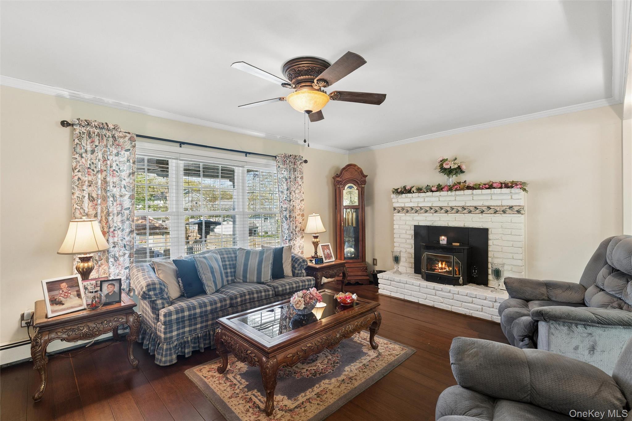 5045 Main Bayview Road Southold, NY 11971 - Photo 4 of 30 a living room with furniture a fireplace and a chandelier