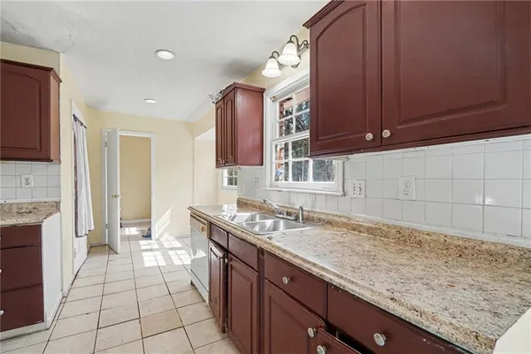 a kitchen with a sink stove and cabinets