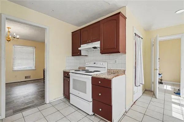 a kitchen with stainless steel appliances granite countertop a stove and a refrigerator