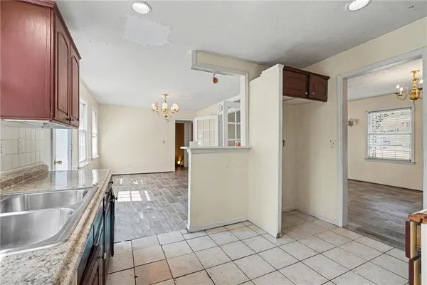 a kitchen with granite countertop a refrigerator and a sink
