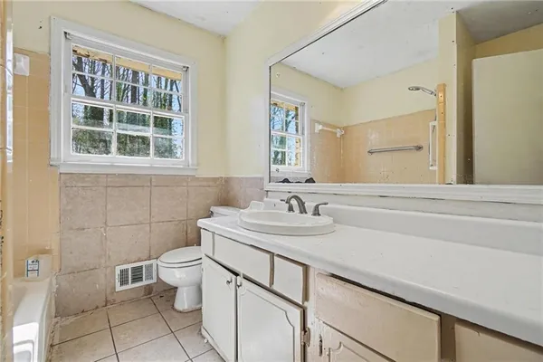 a bathroom with a sink toilet and mirror