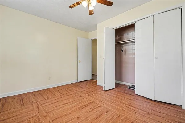 a view of empty room with wooden floor