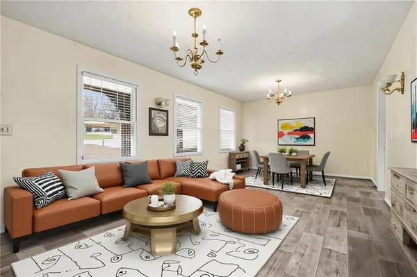 a living room with furniture and a chandelier