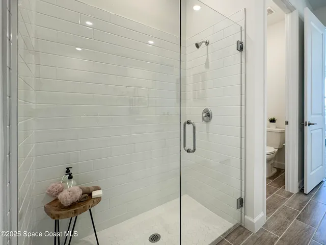 a bathroom with a shower and a sink