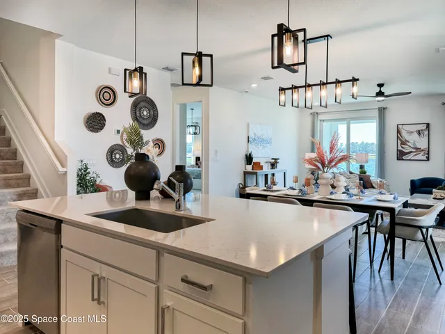 a kitchen with a sink a stove and chairs