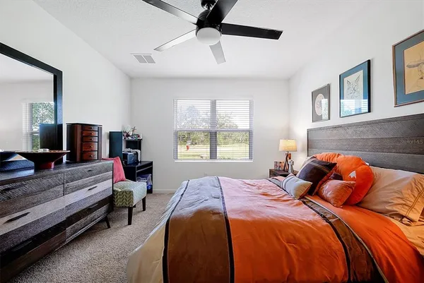 a bedroom with a bed and a couch