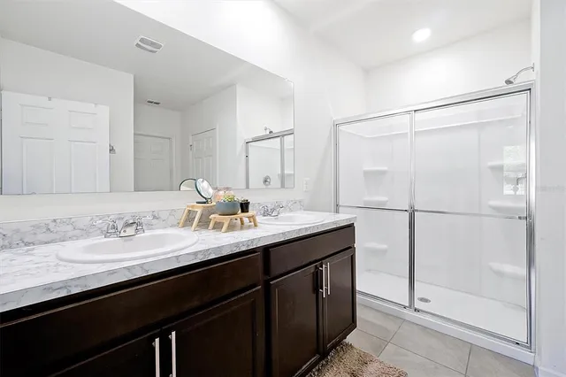 a bathroom with a granite countertop sink mirror and double