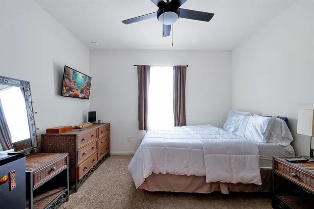 a bedroom with a bed and a tv