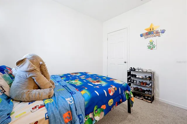 a bedroom with a bed and a couch