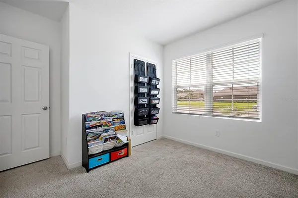 a room with a book shelf and a window