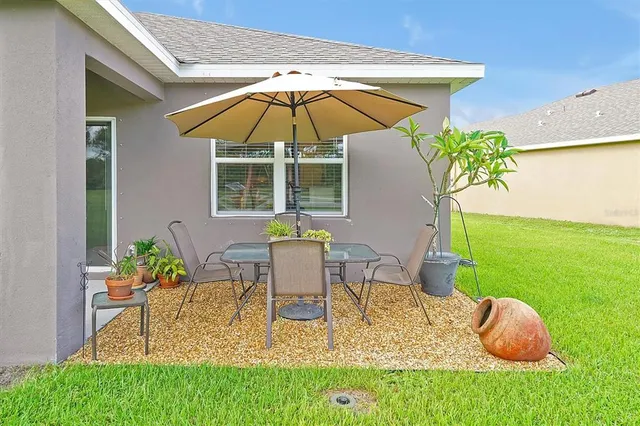 a balcony with furniture and a potted plant