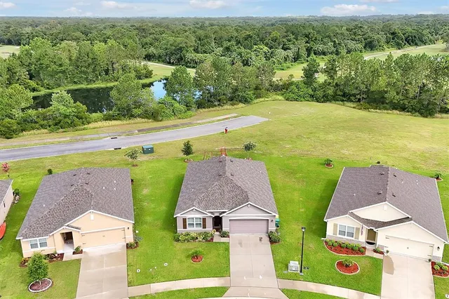 an aerial view of residential houses with outdoor space and street view
