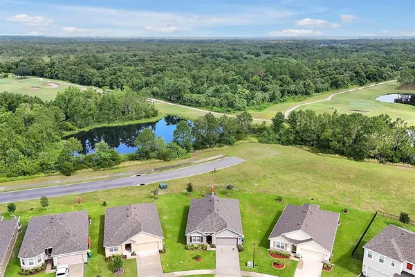 an aerial view of a house with swimming pool and outdoor space