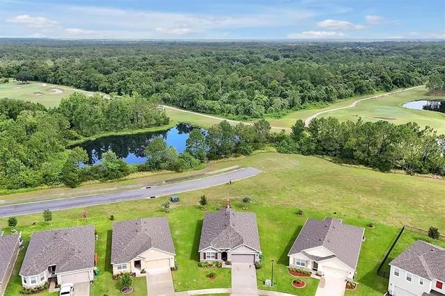 an aerial view of a house with swimming pool and outdoor space