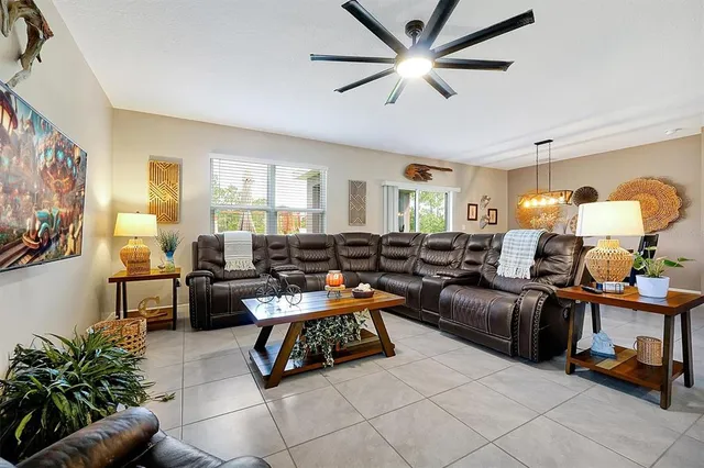 a living room with furniture and a potted plant