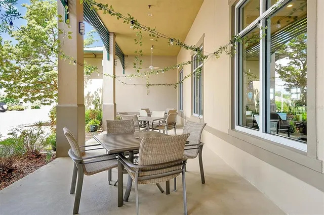 a view of a backyard with brick wall and a small yard