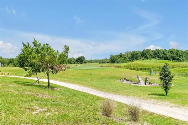 an aerial view of a golf course with parking space