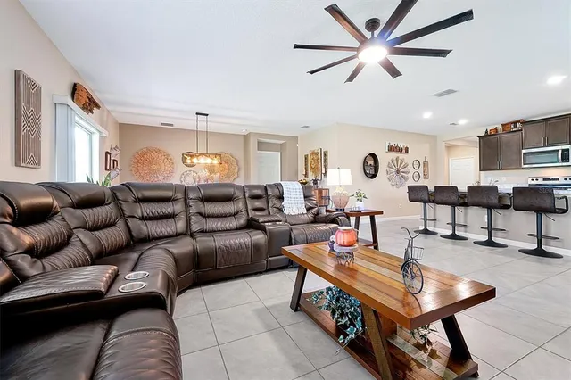 a living room with furniture and kitchen view